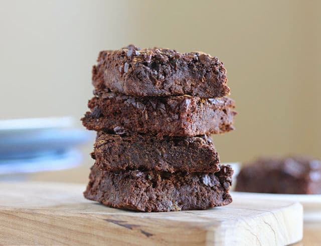 Stack of healthy brownies on a wood board.