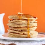 Stack of banana pancakes with maple syrup.