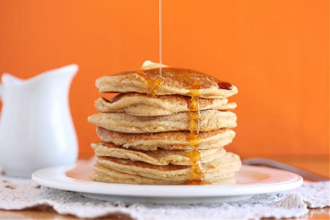 Stack of banana pancakes with maple syrup.