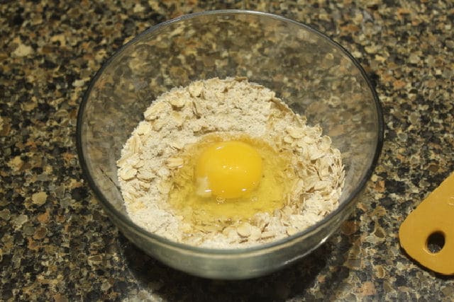 Oats, oat flour, and egg in a bowl.