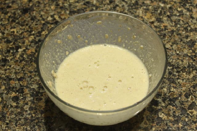 Oatmeal pancake batter in a glass bowl.