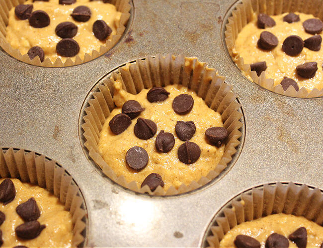 Pre-baked muffins in paper-lined muffin cups with chocolate chips on top.
