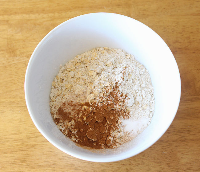 Oat flour, cinnamon, and salt in a white bowl.