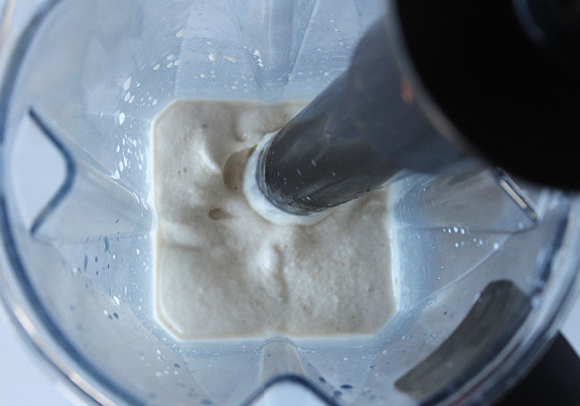 Blending ice cream in a Vitamix blender with a tamper.