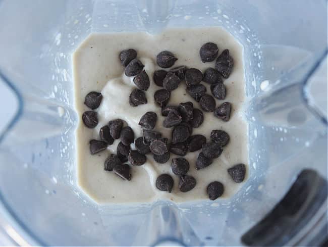 Ice cream and chocolate chips in a blender.