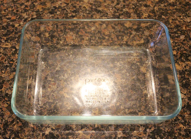 Empty glass dish on a granite countertop.