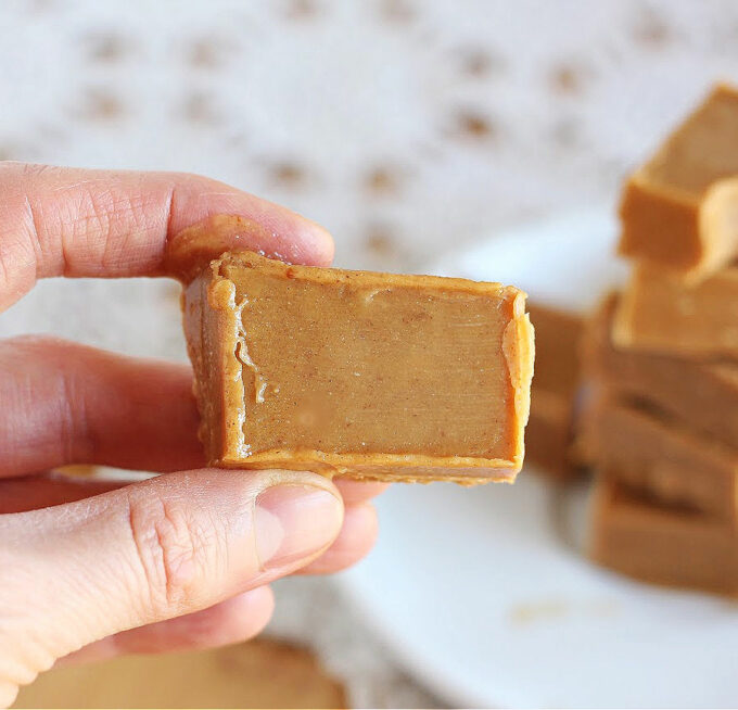 Hand holding a piece of peanut butter fudge.