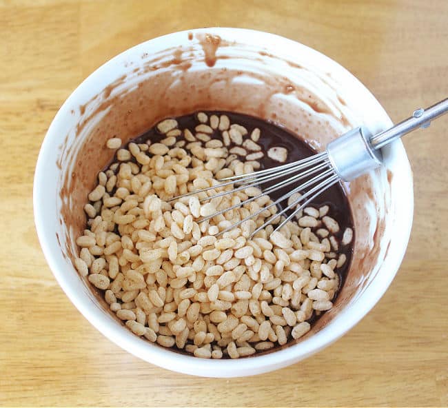 Chocolate and rice krispie cereal in a white bowl.