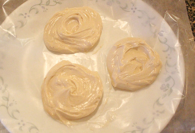 Dollops of Greek yogurt mixed with maple syrup on a wax papered plate.