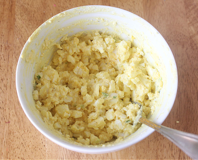 Prepared egg salad in a white bowl.