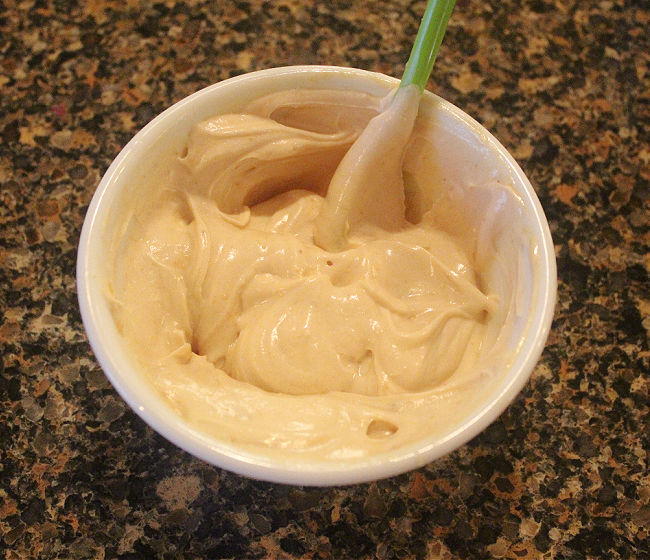 Greek yogurt mixed with peanut butter in a bowl.