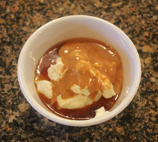 Yogurt, peanut butter, maple syrup, and vanilla in a bowl.