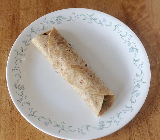 Rolled tortilla on a white plate.