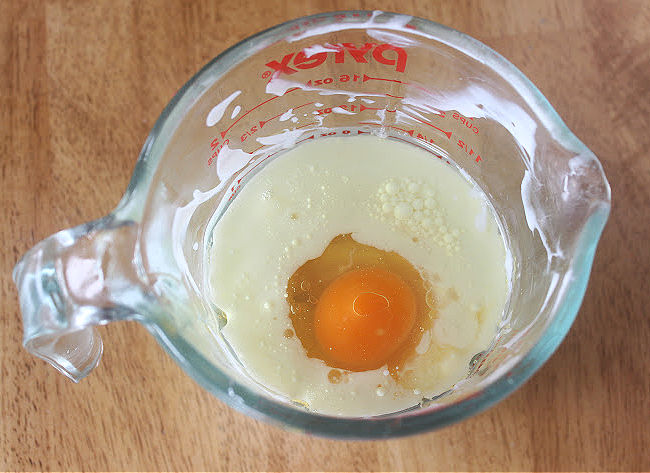 Yogurt, egg, and oil in a large measuring pitcher.