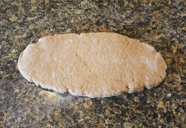 Rolled out dough on a granite counter.