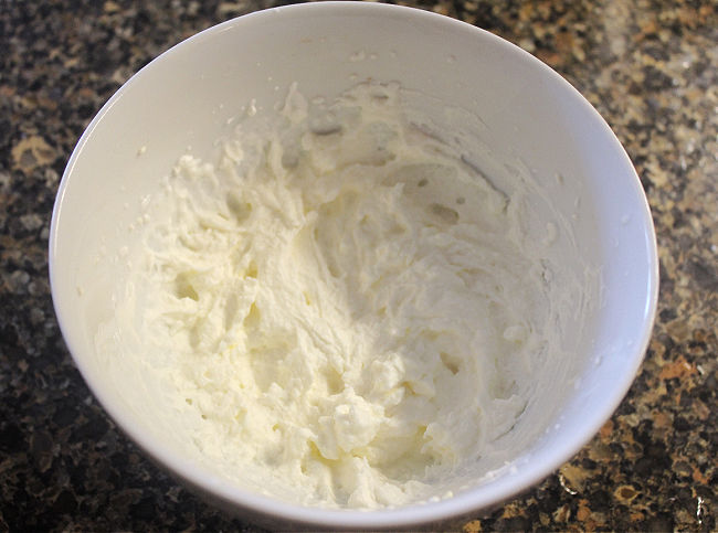 Whipped cream in a white bowl.