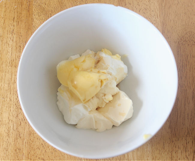 Yogurt, butter, and sugar in a bowl.