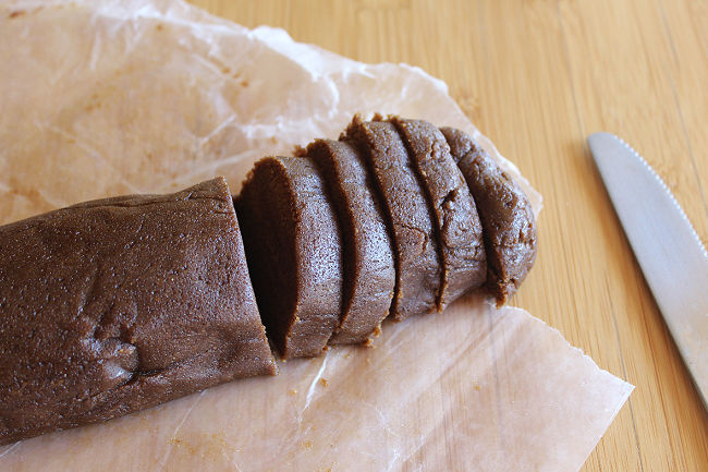 Slicing homemade cookie dough log.