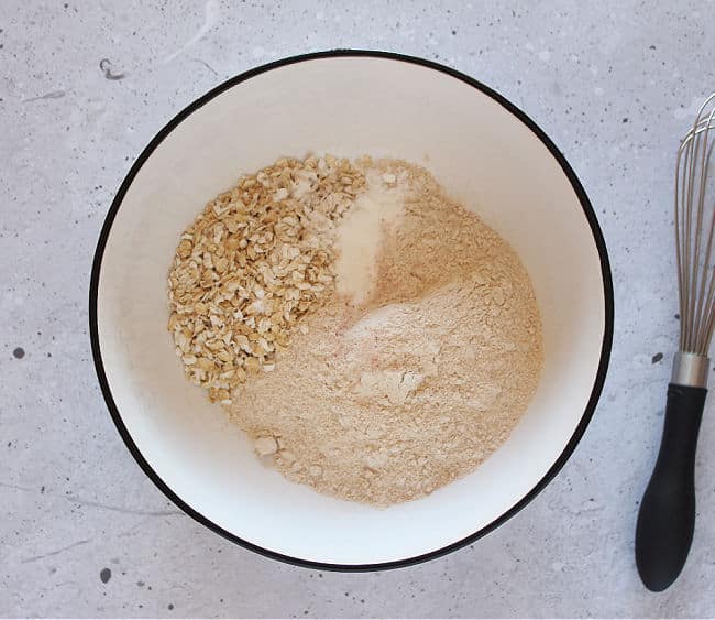 Flour, oats, baking powder, and salt in a bowl.