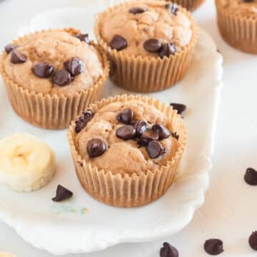 Chocolate chip muffins on a small white platter.