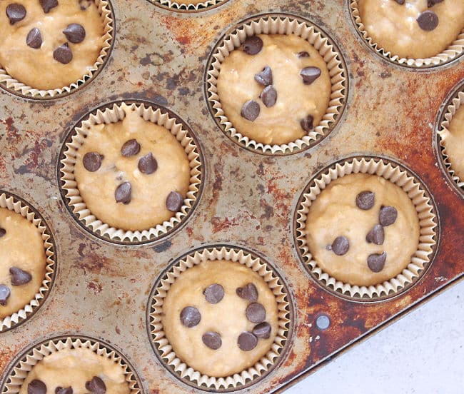 Unbaked muffins in a muffin tin.