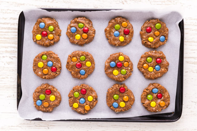 Unbaked monster cookies on a baking sheet.