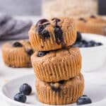 Stack of three blueberry muffins.