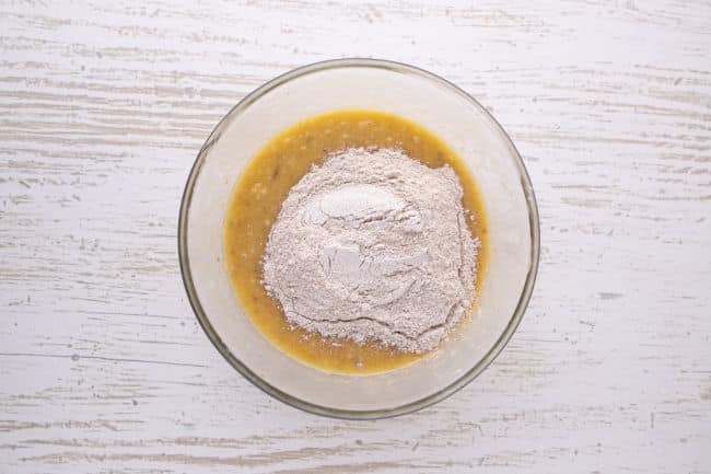 Banana, egg, and flour in a bowl.