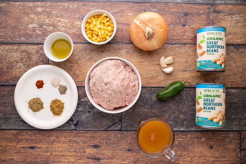 Ground turkey, vegetables, and spices laid out on a table.