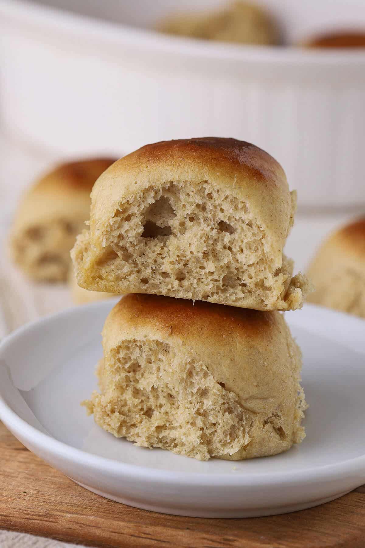 Stack of two dinner rolls on a plate.