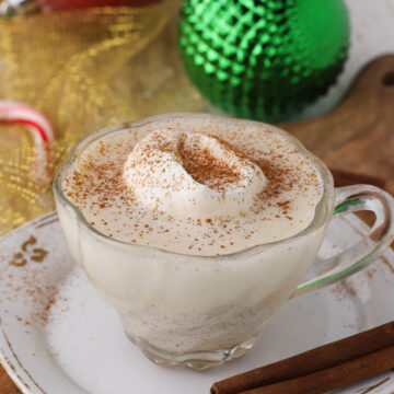 Eggnog with whipped cream in a mug.