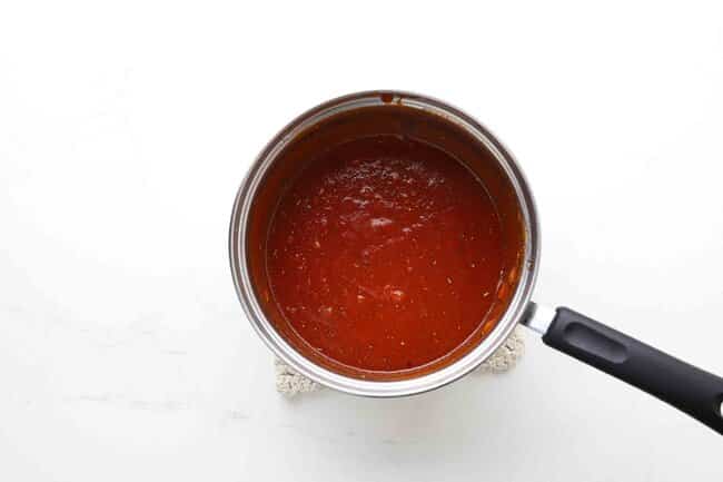Cooking marinara sauce in a pan.