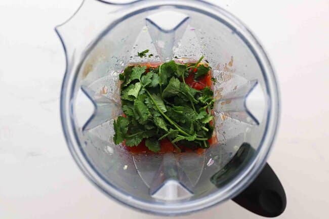 Tomatoes and cilantro in a blender.