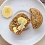 Buttered muffin on a plate.