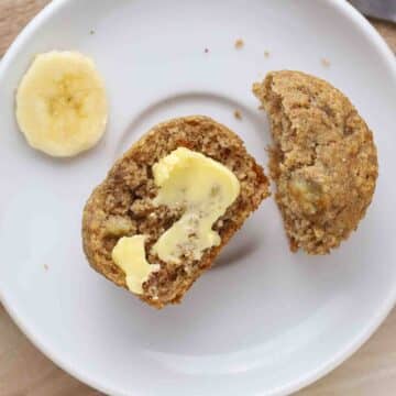 Buttered muffin on a plate.