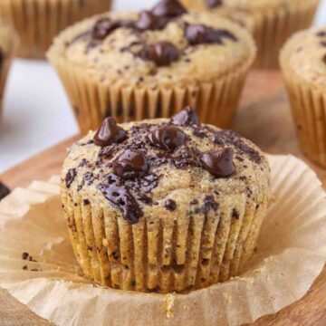 Chocolate chip muffins on a cutting board.