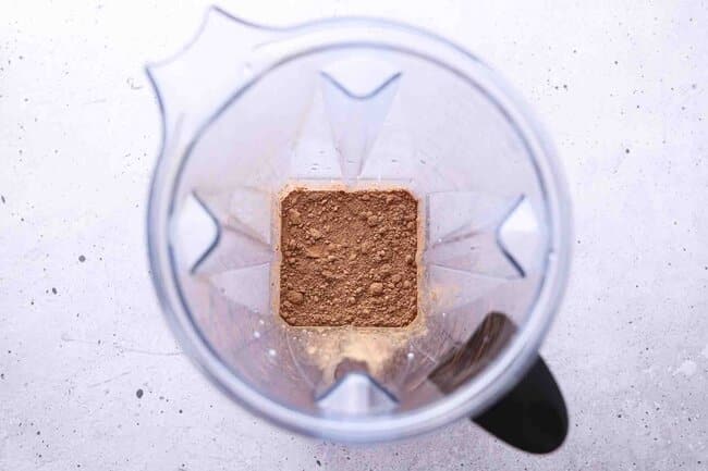 Milk and cocoa powder in a blender.